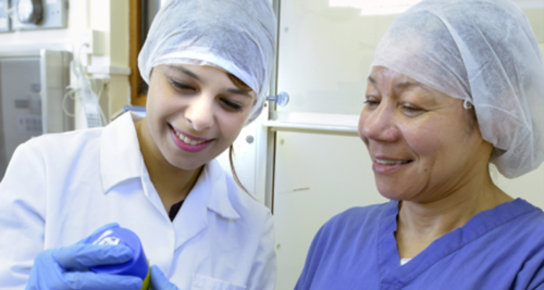 Two lab technicians wearing hair masks and lab coats 