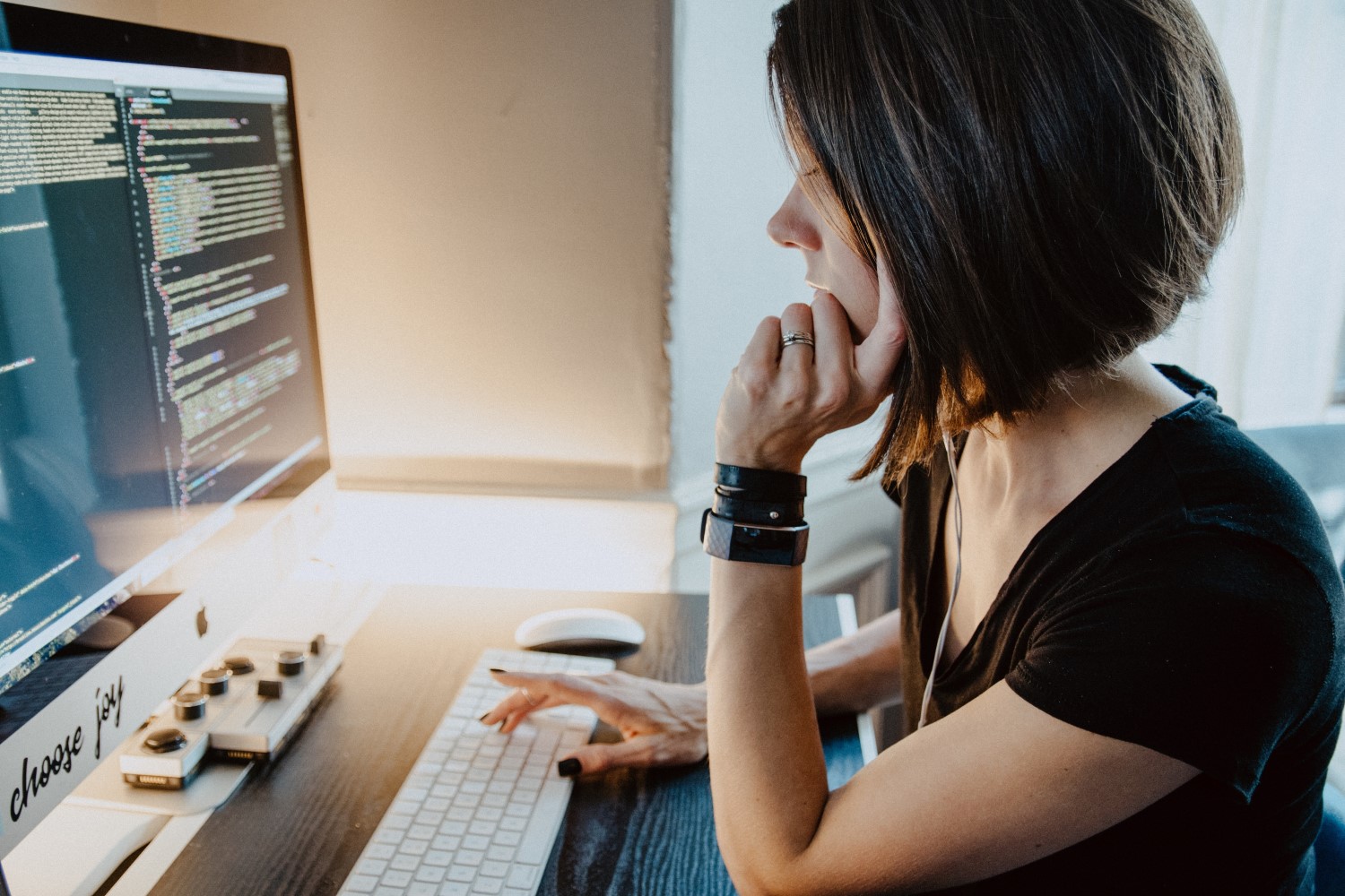 Woman working on a computer reading code 