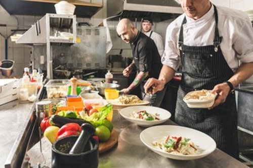 Apprentice Commis Chef working in a busy kitchen 