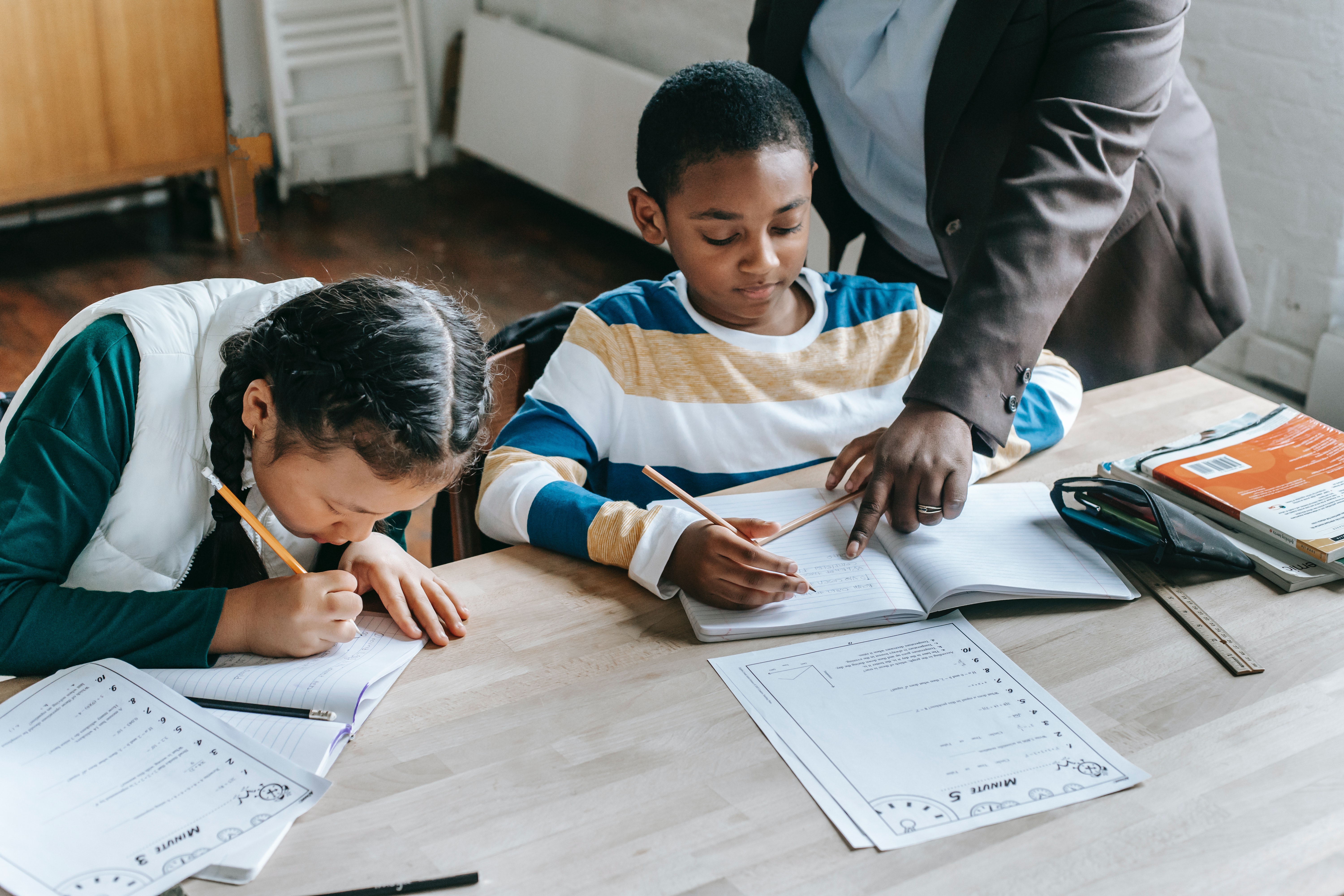 two young children having help with their homework 