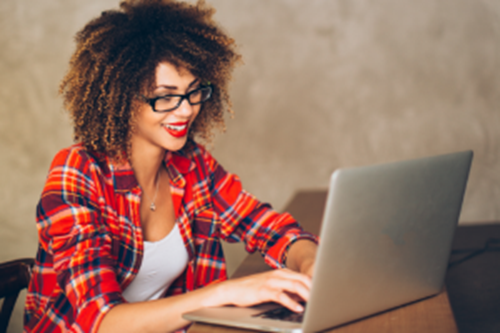 Woman wearing glasses working on laptop