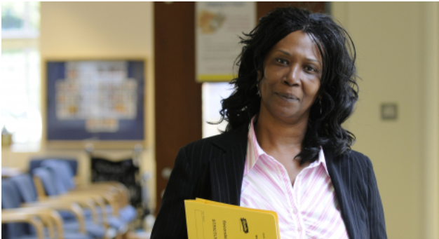 Female manager in office wear smiling in a waiting room 