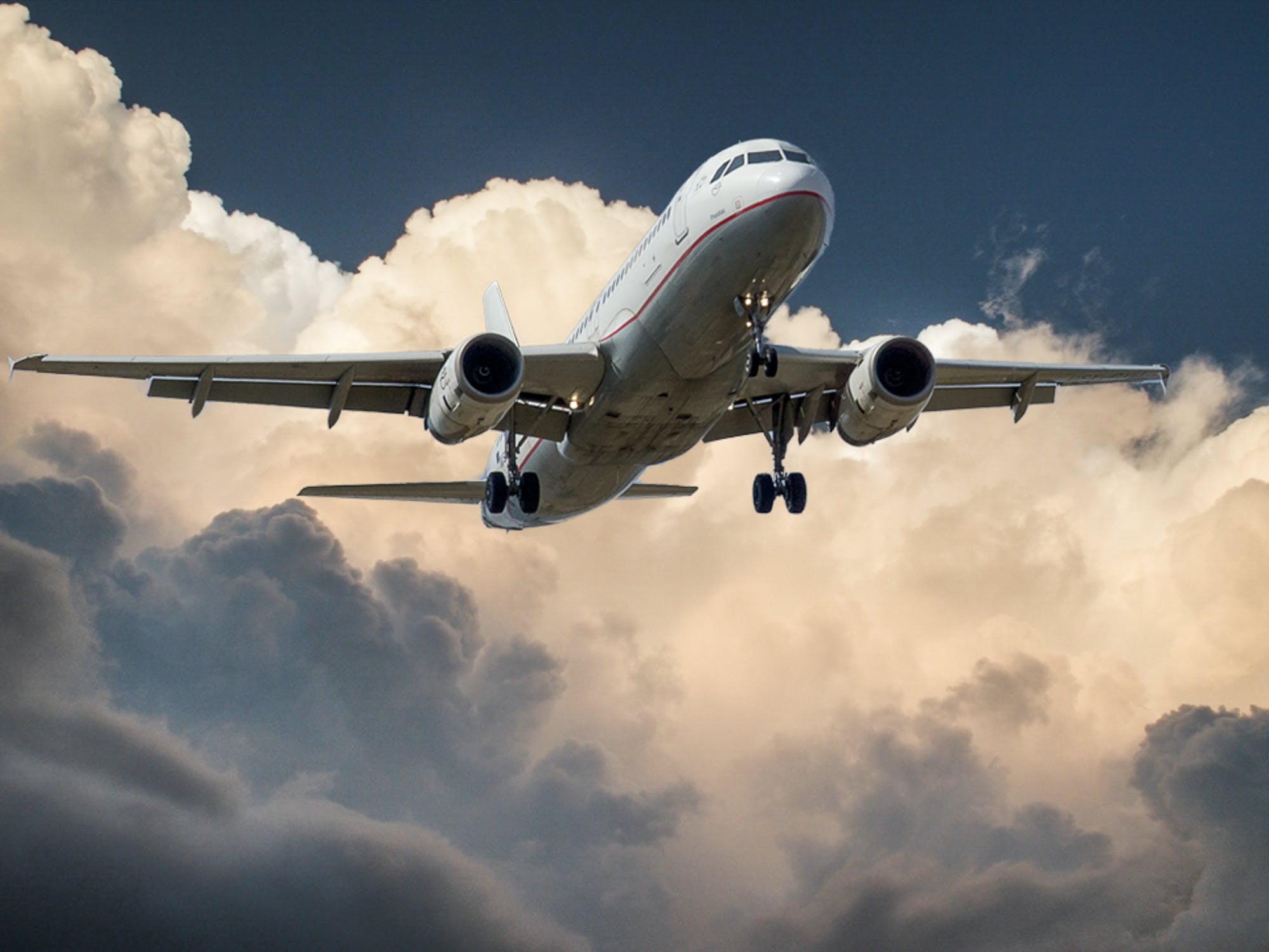 large plane flying in the clouds