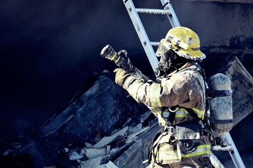 Firefighter at the scene of a burnt building 